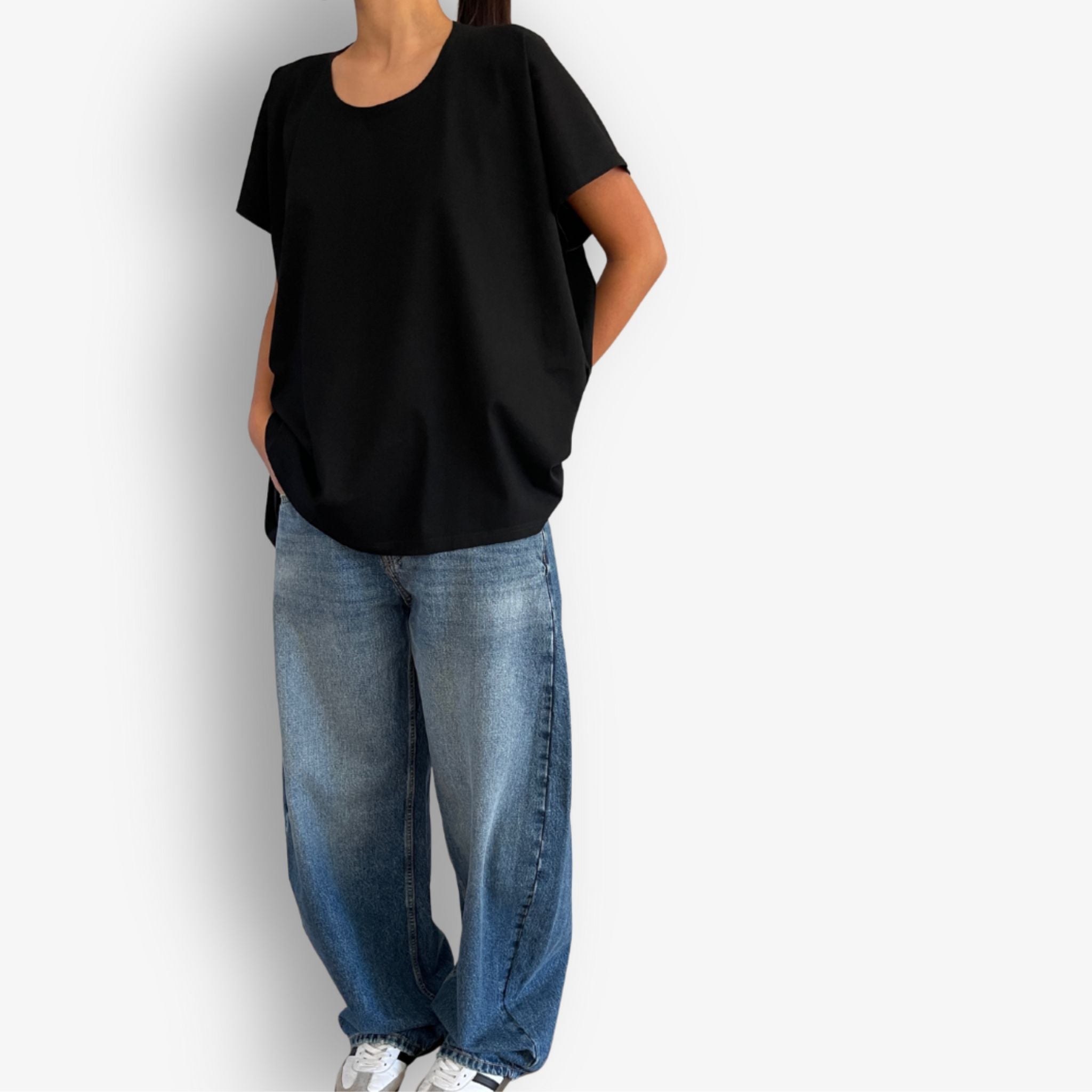 Model wearing black folded short sleeve high low cotton t-shirt