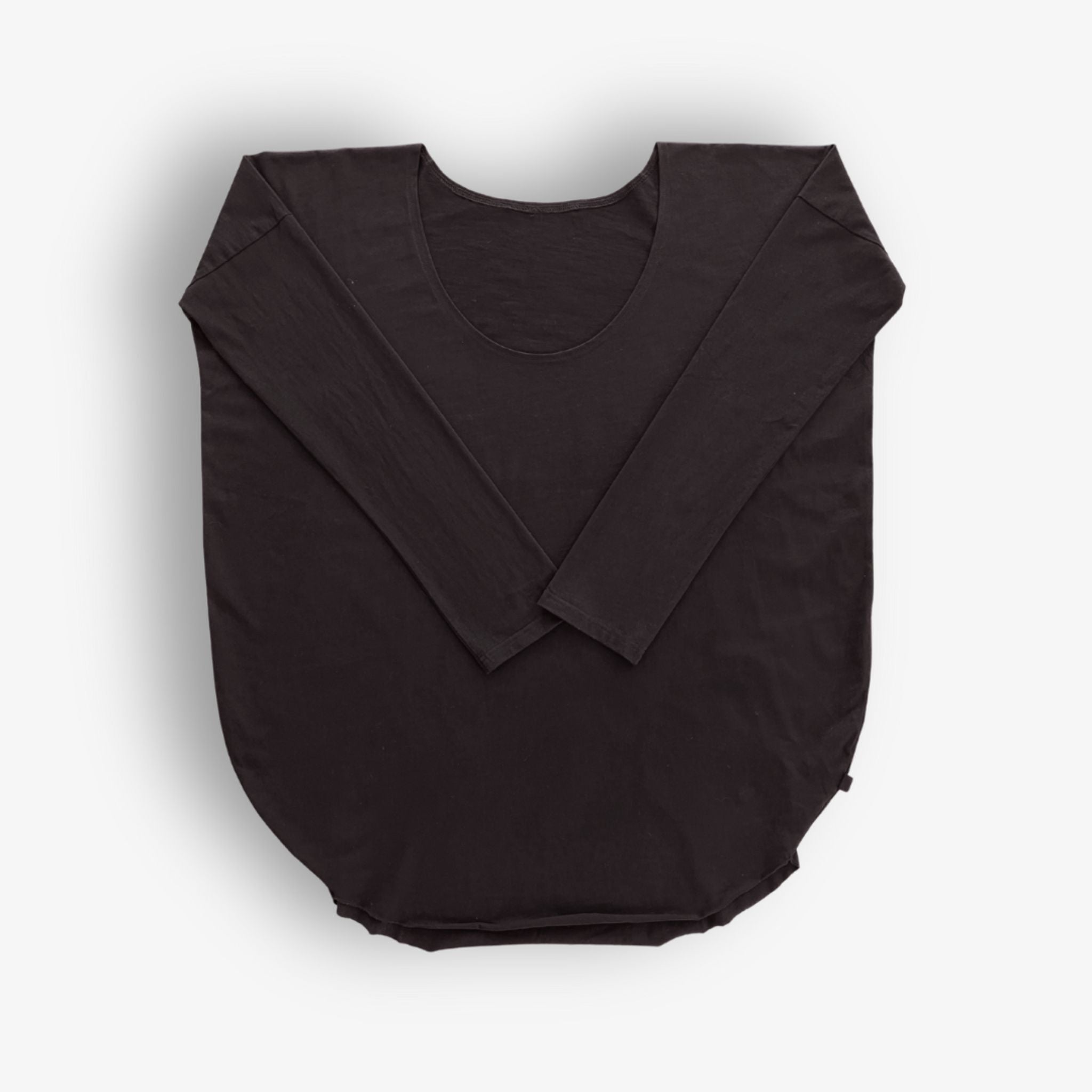 Detail of fabric and hemline of Two Daughters reversible long sleeve circular t‑shirt in black.