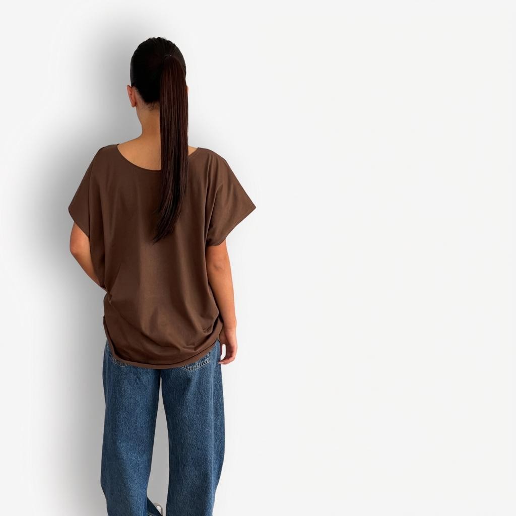 Brown oversized T-shirt styled with high-waisted AGOLDE Luna Barrel jeans, featuring a relaxed, slouchy silhouette on top paired with structured, curved-leg light-wash denim for a modern, effortless look.