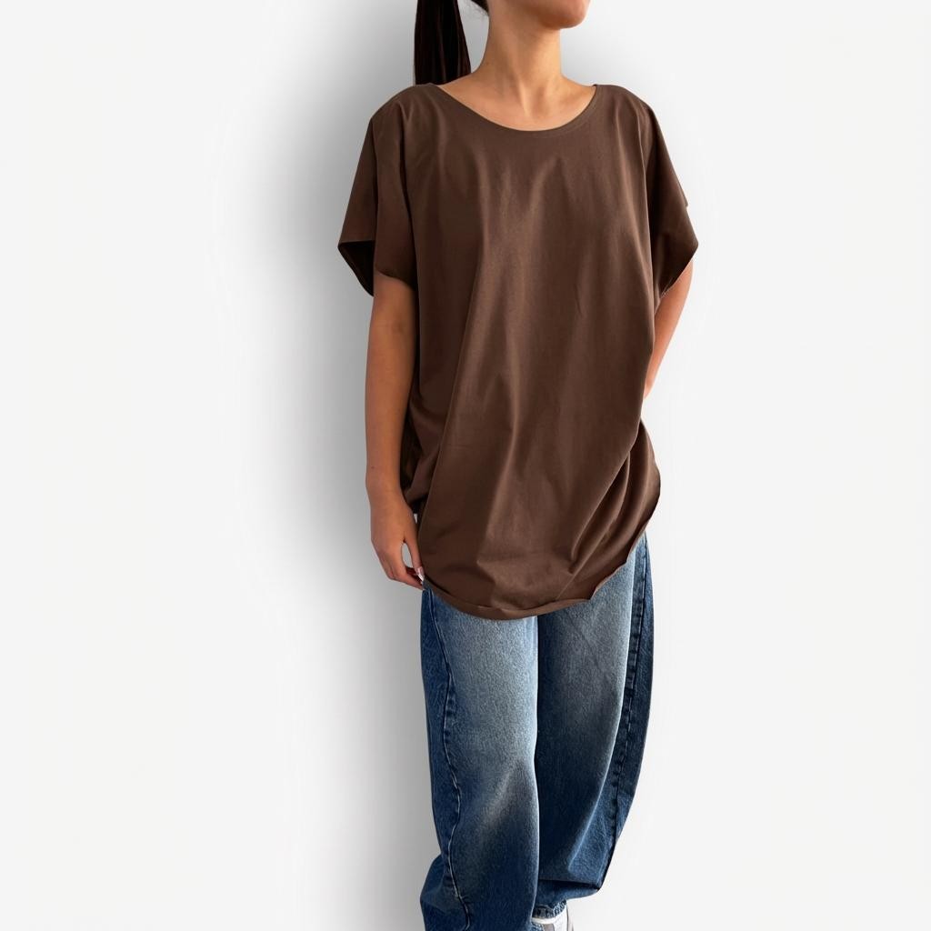 Brown oversized T-shirt styled with high-waisted AGOLDE Luna Barrel jeans, featuring a relaxed, slouchy silhouette on top paired with structured, curved-leg light-wash denim for a modern, effortless look.