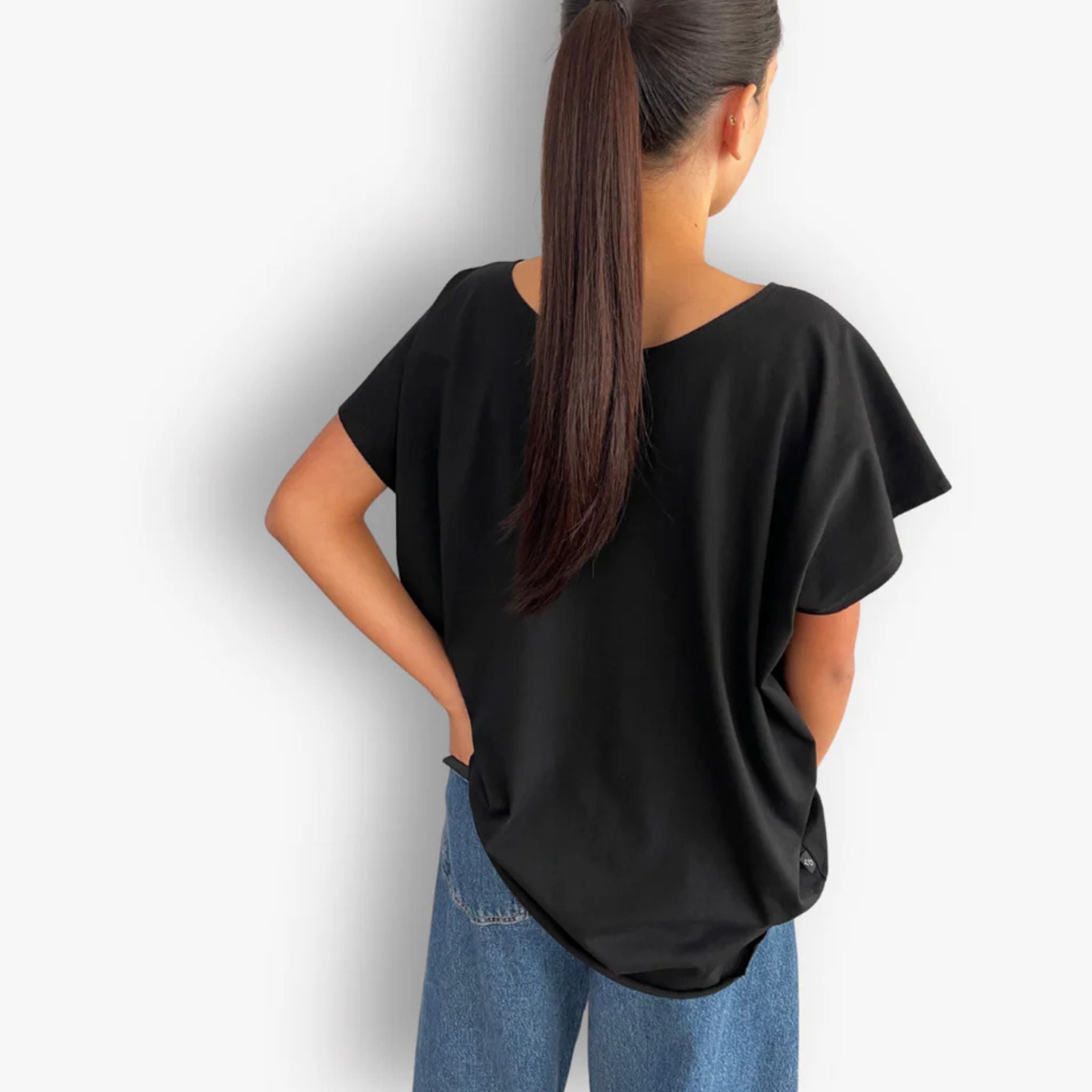 Back view of oversized black circular hem short sleeve cotton t-shirt