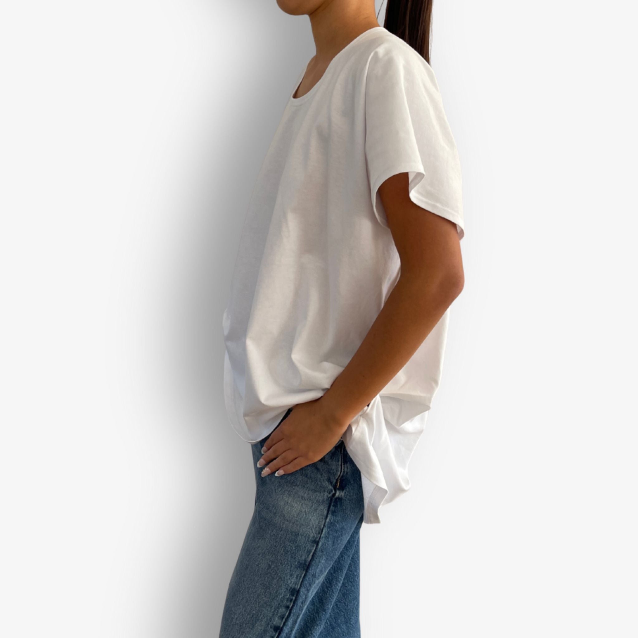 Model wearing white high low folded sleeve cotton t-shirt